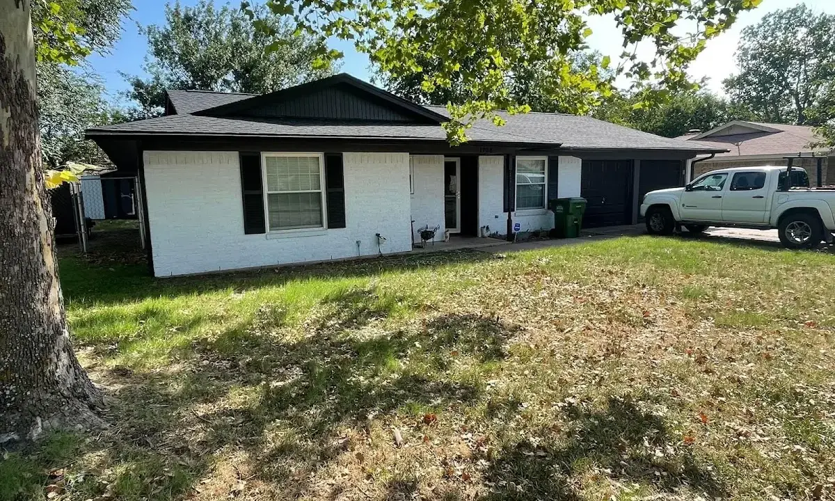 Professional roofing crew working on a residential roof in Rainbow City